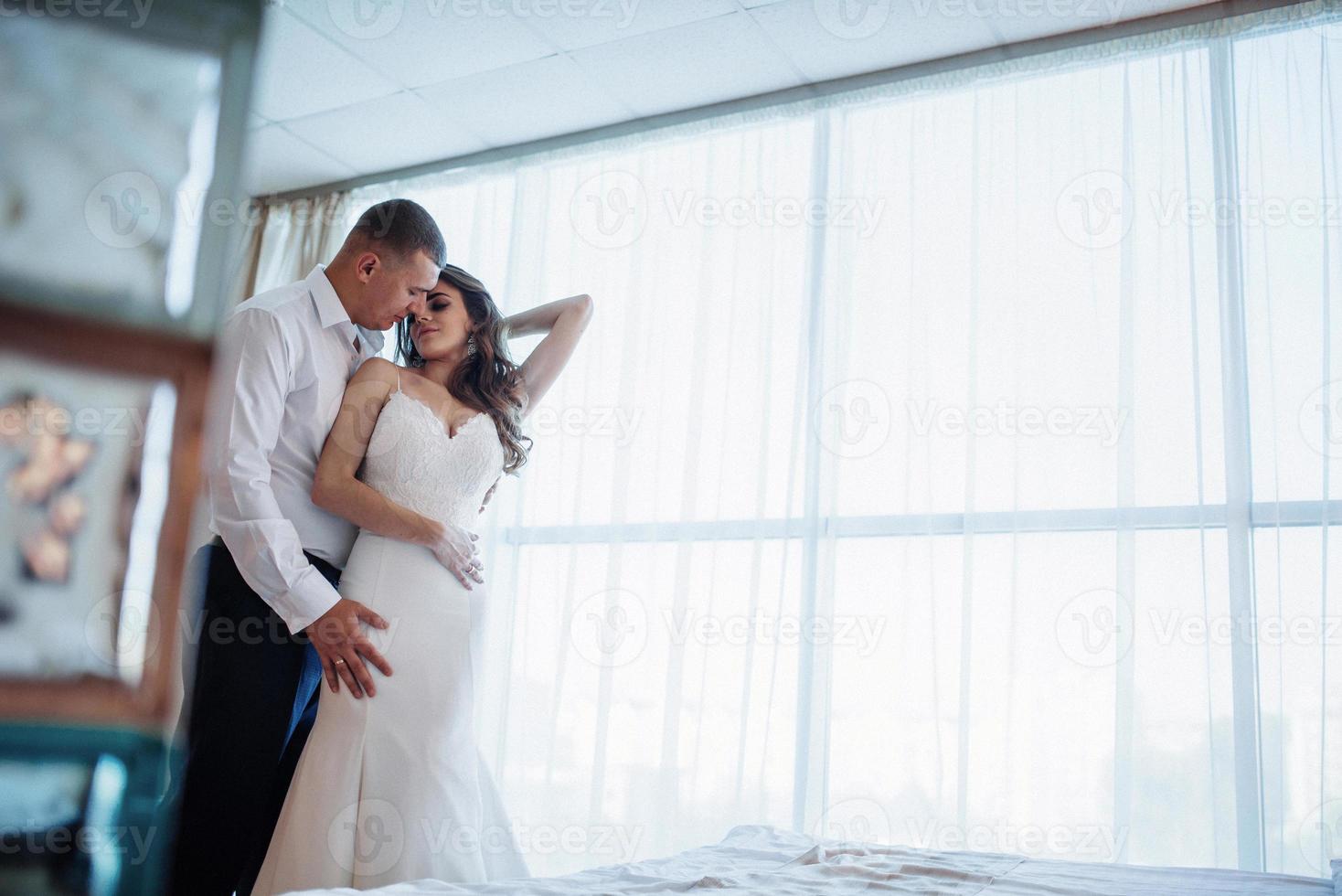 Wedding couple in hotel room photo