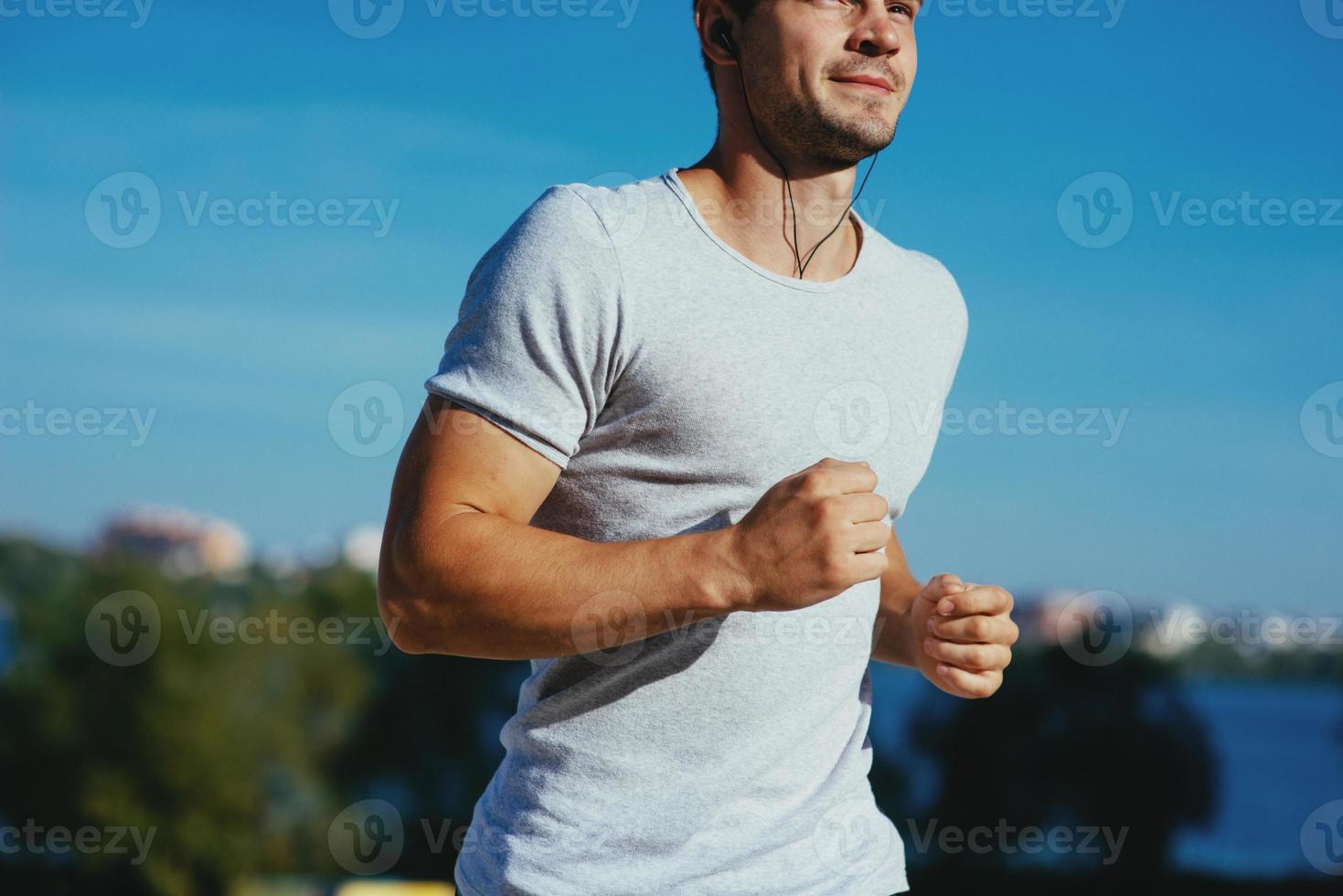 Attractive strong athlete running photo