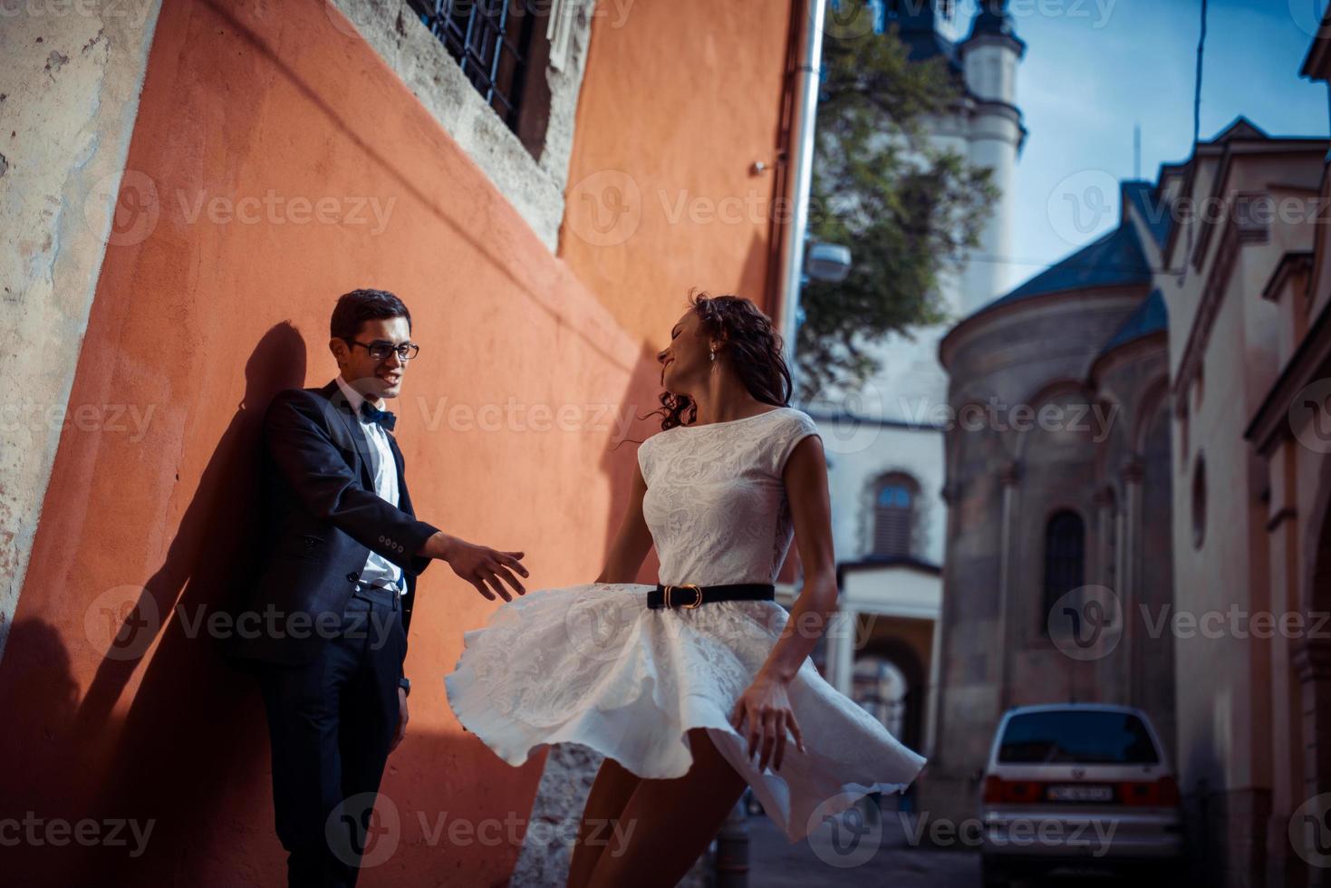 Young couple in love, hugging in the old part of town photo