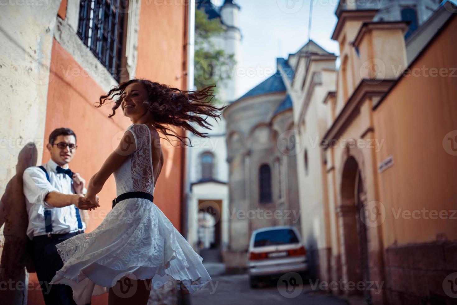 Young couple in love, hugging in the old part of town photo