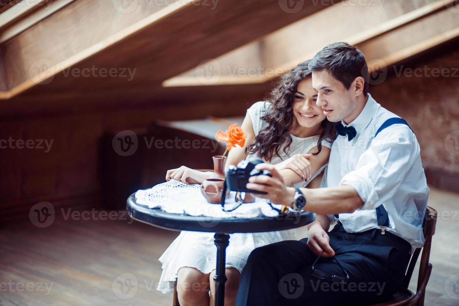 Romantic couple in love bonding in cafe photo