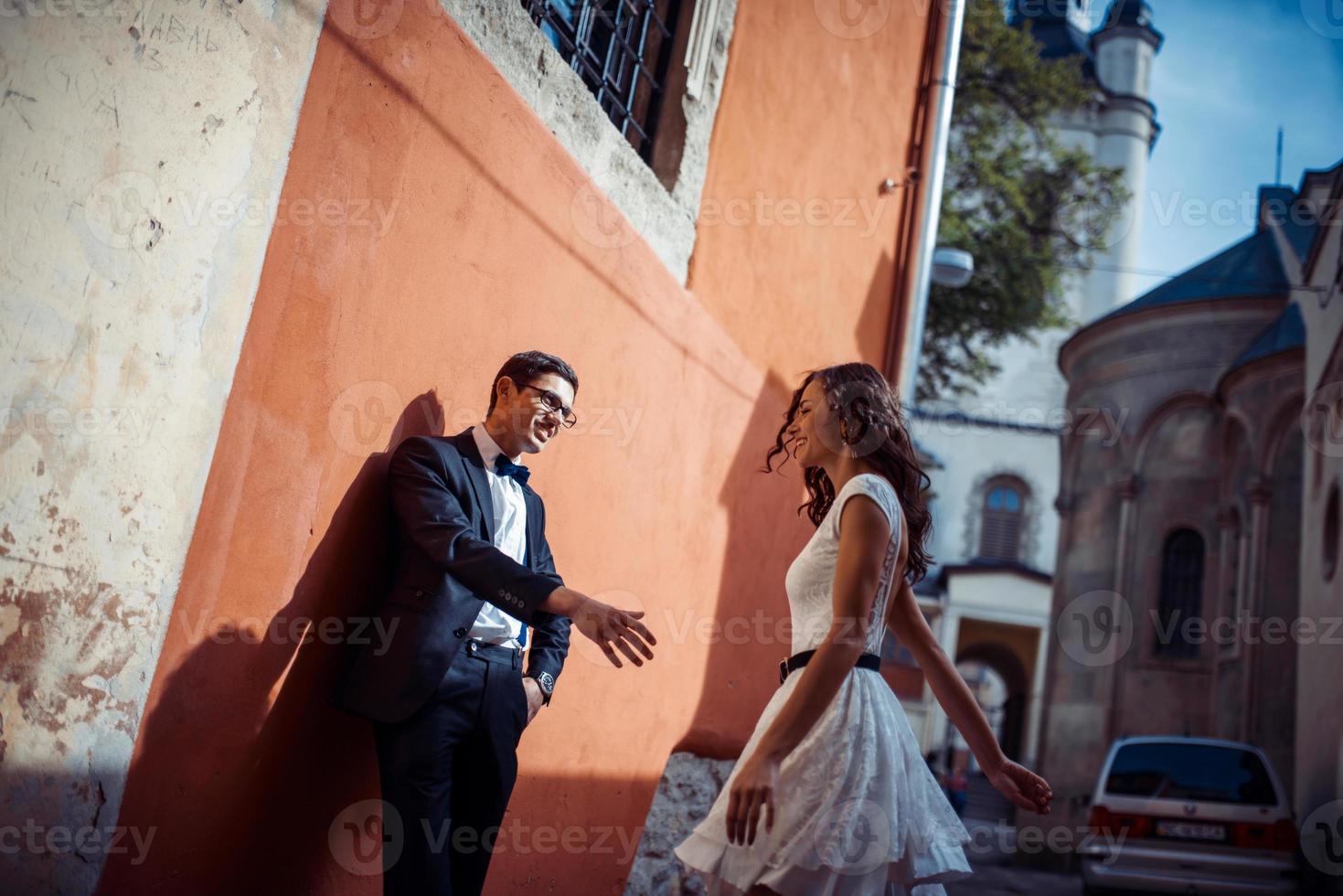 Young couple in love, hugging in the old part of town photo