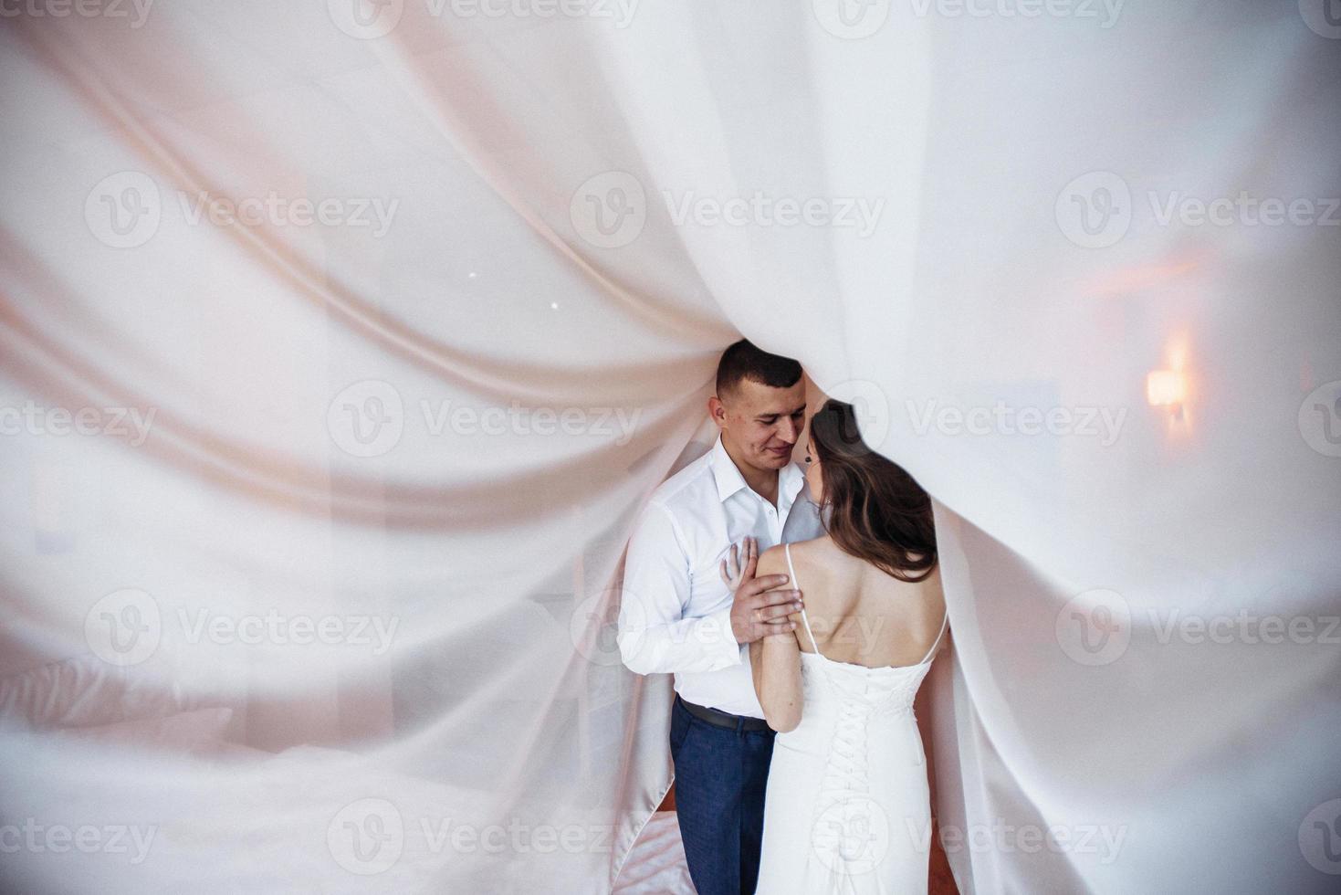 Wedding couple in hotel room photo