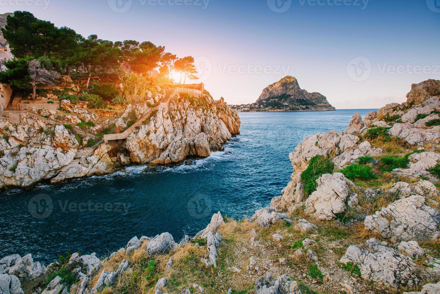 Sunset over the sea with rocks photo