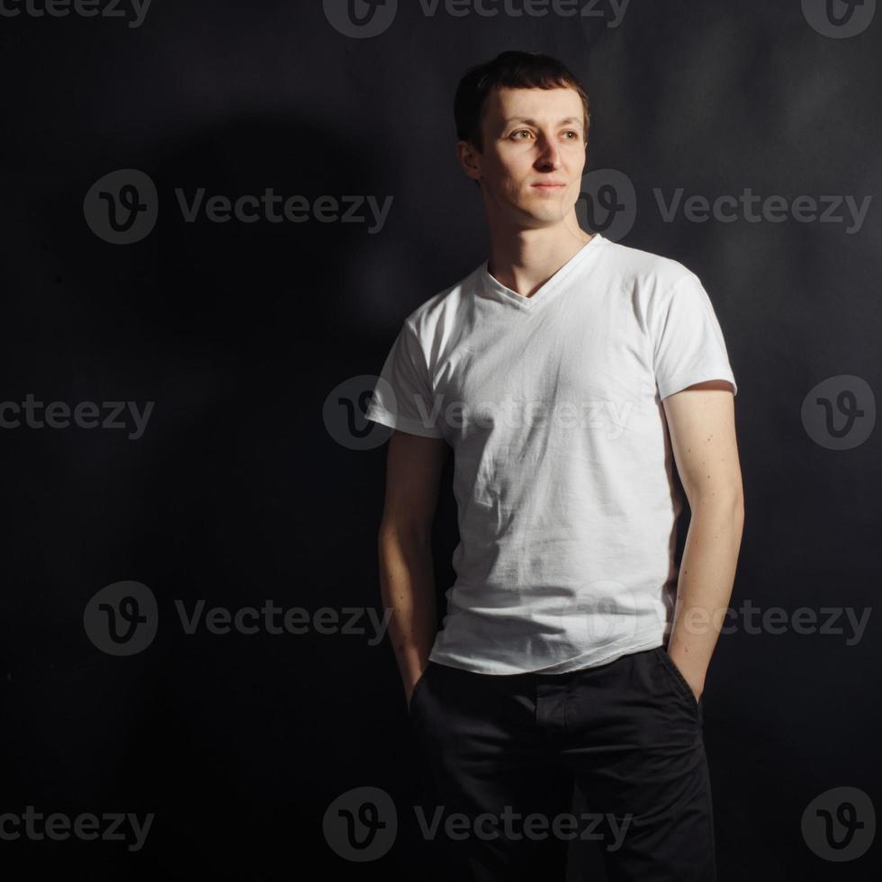 Beautiful young man in white shirt photo