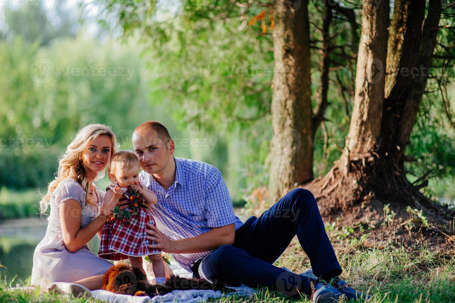 happy family are walking in the green summer park photo