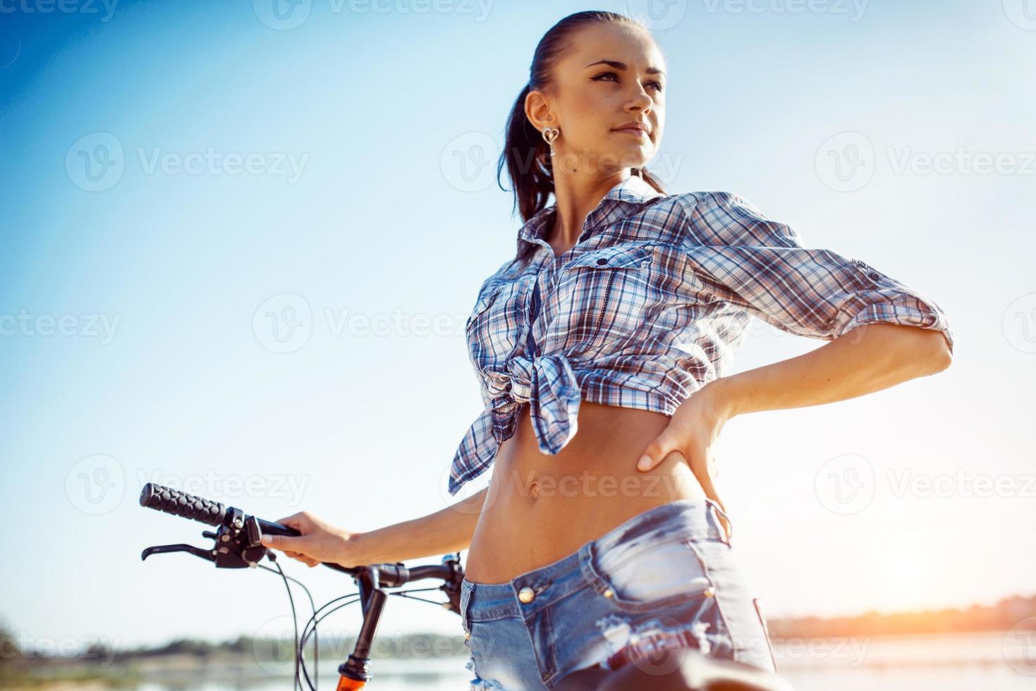 woman on a bicycle in beach photo