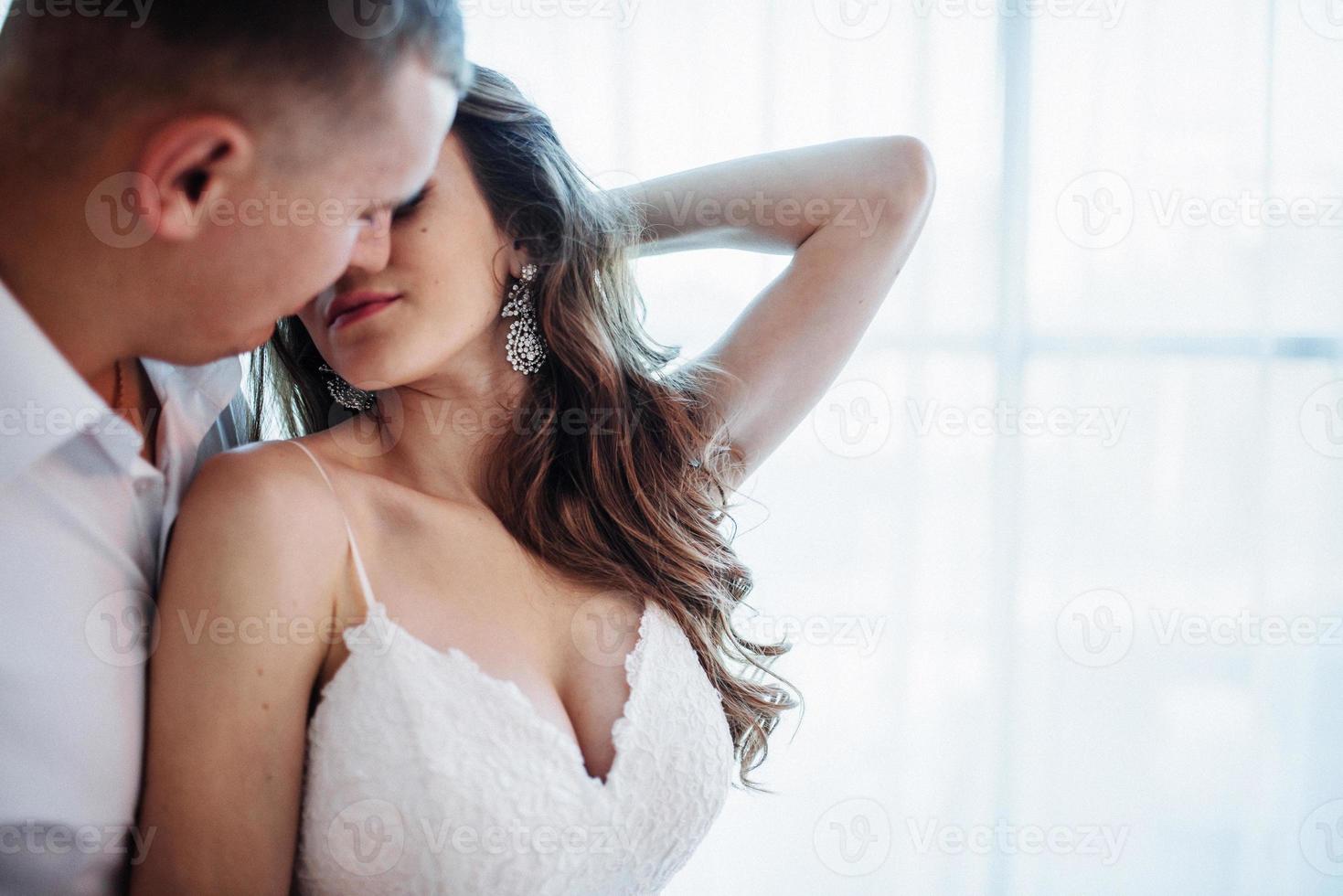 Wedding couple in hotel room photo