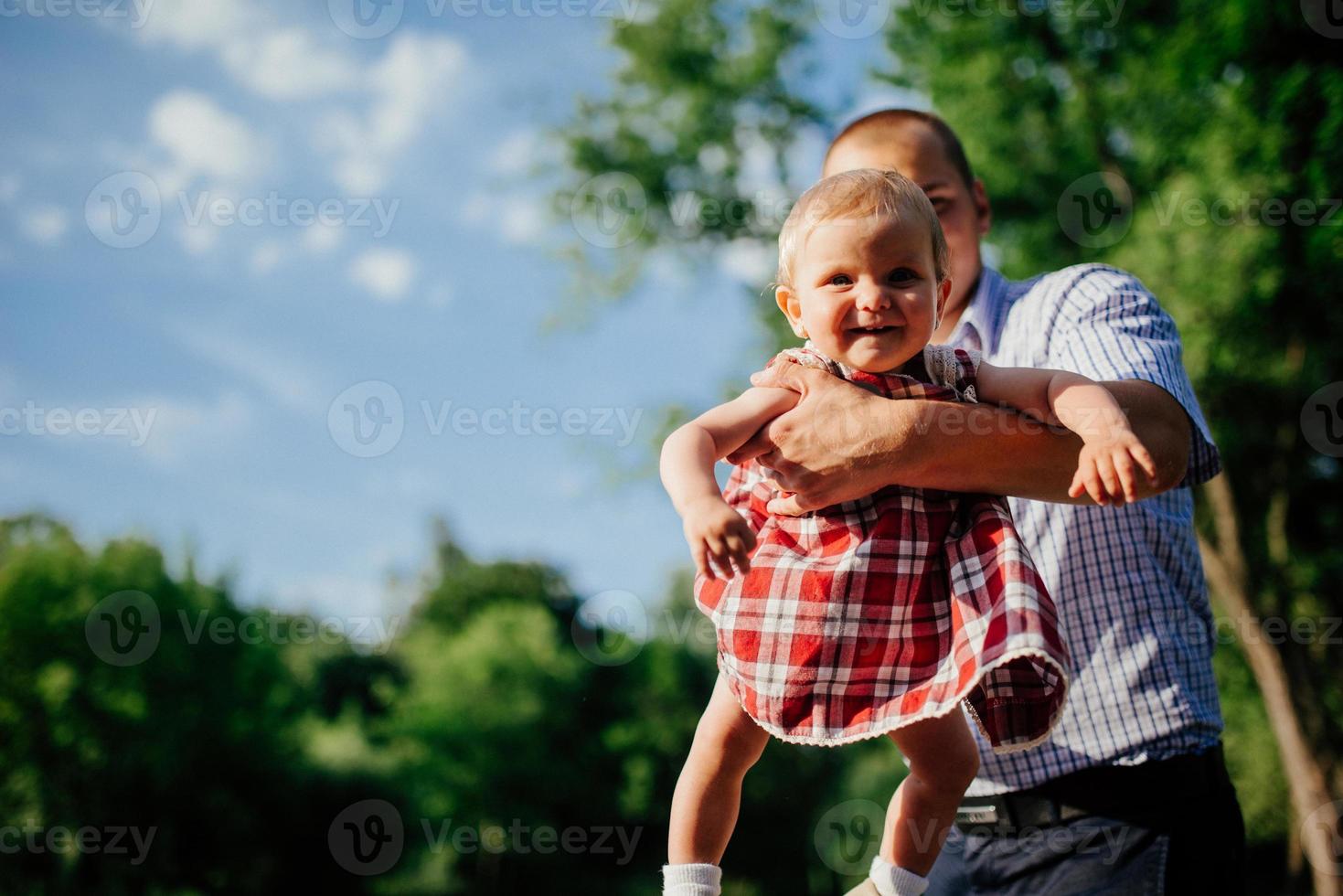 father and daughter. man and beautiful little girl outdoors in park photo