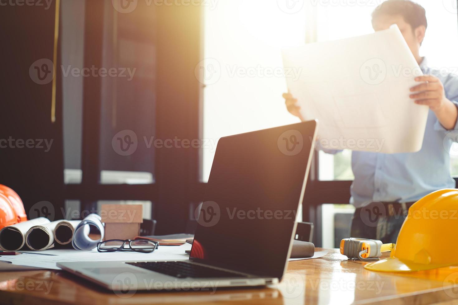 Business objects of architect on desk with engineer tools and architect analyzer working with blueprints and model house,Team meeting concept.Project ideas concept.Vintage effect,selective focus. photo