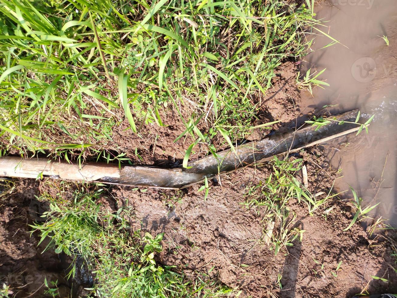 PHOTOS OF FARMER'S SIMPLE WATER DISPOSAL, DAY TIME . made using simple materials using bamboo. some use a pipe.