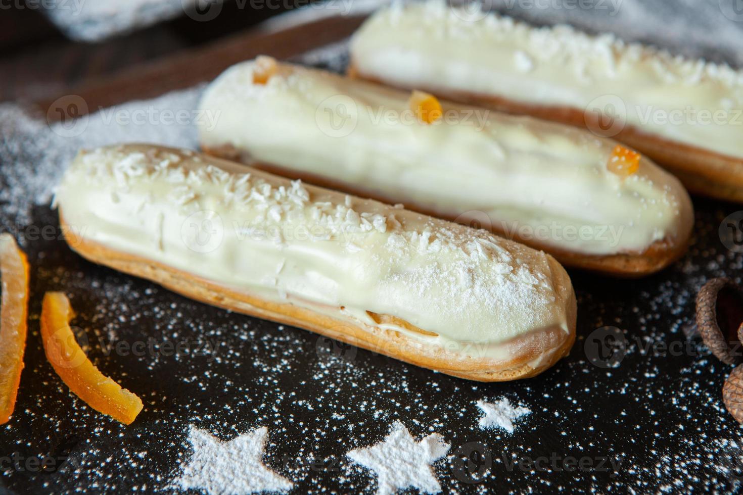 Traditional french eclairs with chocolate. Tasty dessert. Home made cake eclairs. Sweet Dessert Pastry filled with cream. Chocolate icing. photo