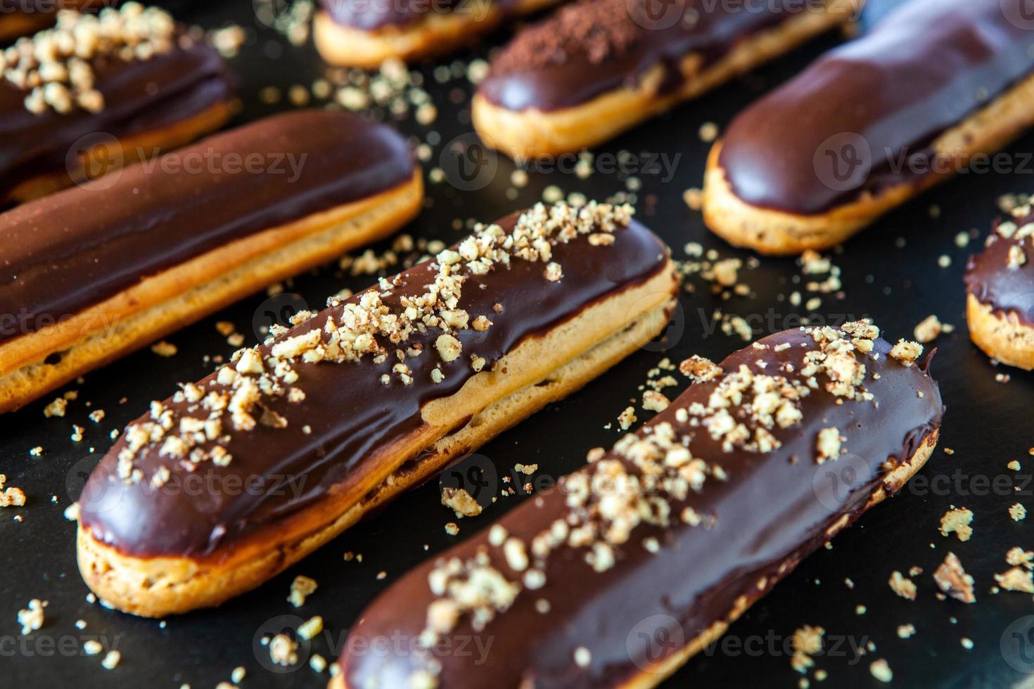 Traditional french eclairs with chocolate. Tasty dessert. Home made cake eclairs. Sweet Dessert Pastry filled with cream. Chocolate icing. photo