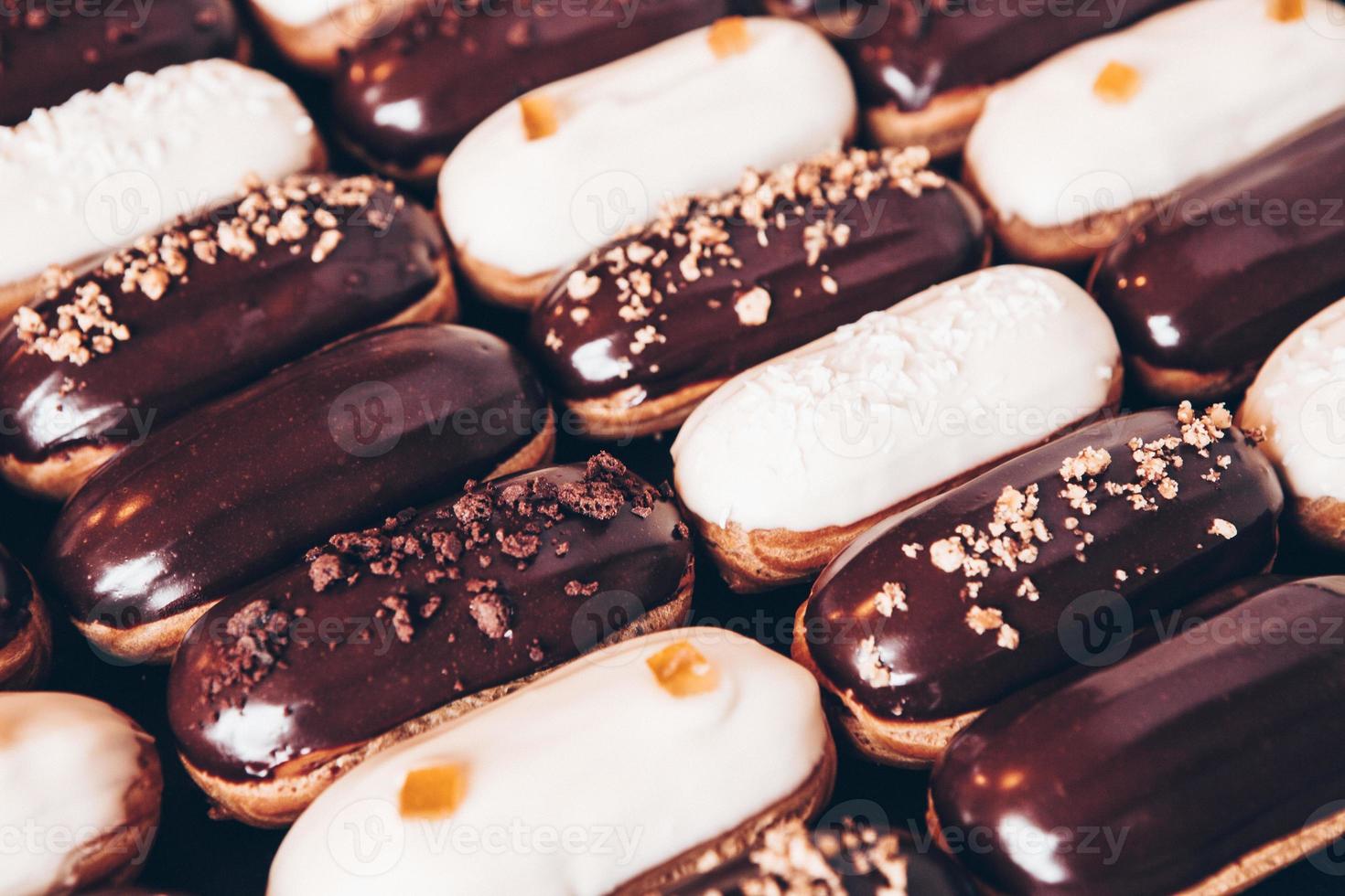 Traditional french eclairs with chocolate. Tasty dessert. Home made cake eclairs. Sweet Dessert Pastry filled with cream. Chocolate icing. photo