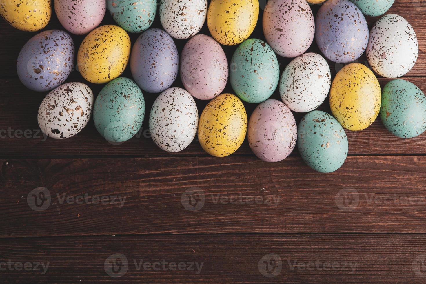 Hand painted pastel colored Easter eggs background. Happy Easter greeting card or invitation. photo