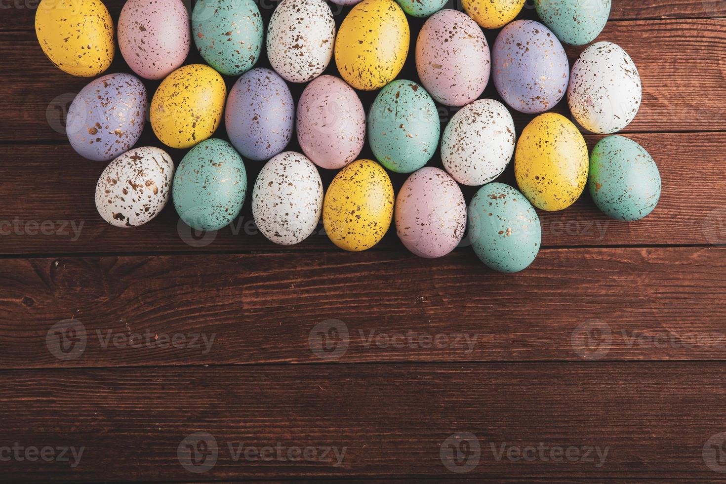 Hand painted pastel colored Easter eggs background. Happy Easter greeting card or invitation. photo