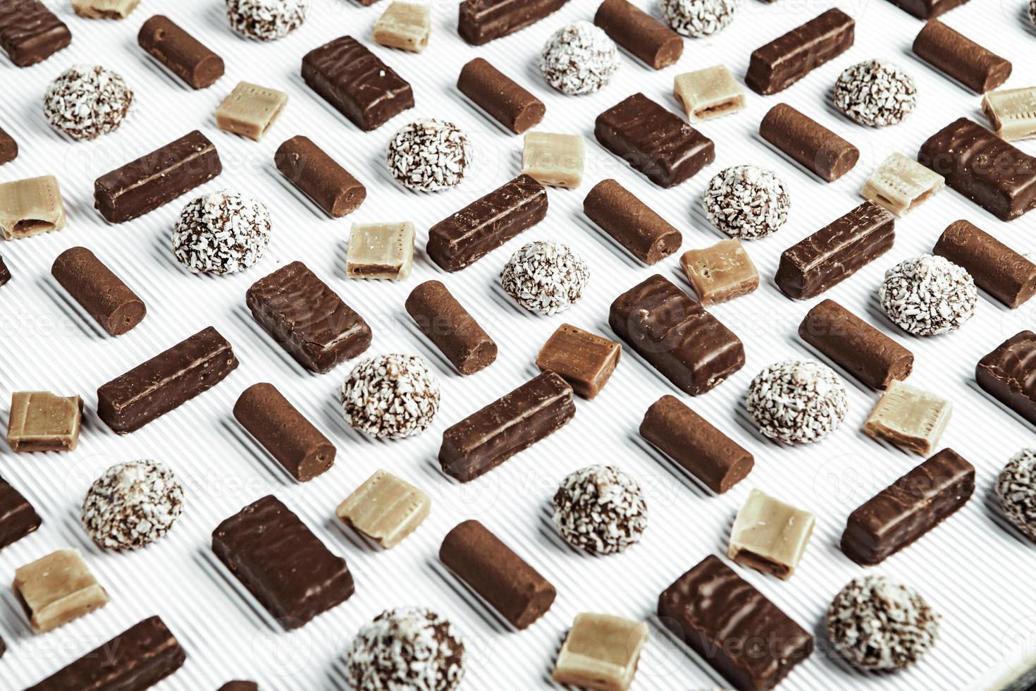 Assortment of delicious chocolate candies background. Chocolate candy isolated. photo
