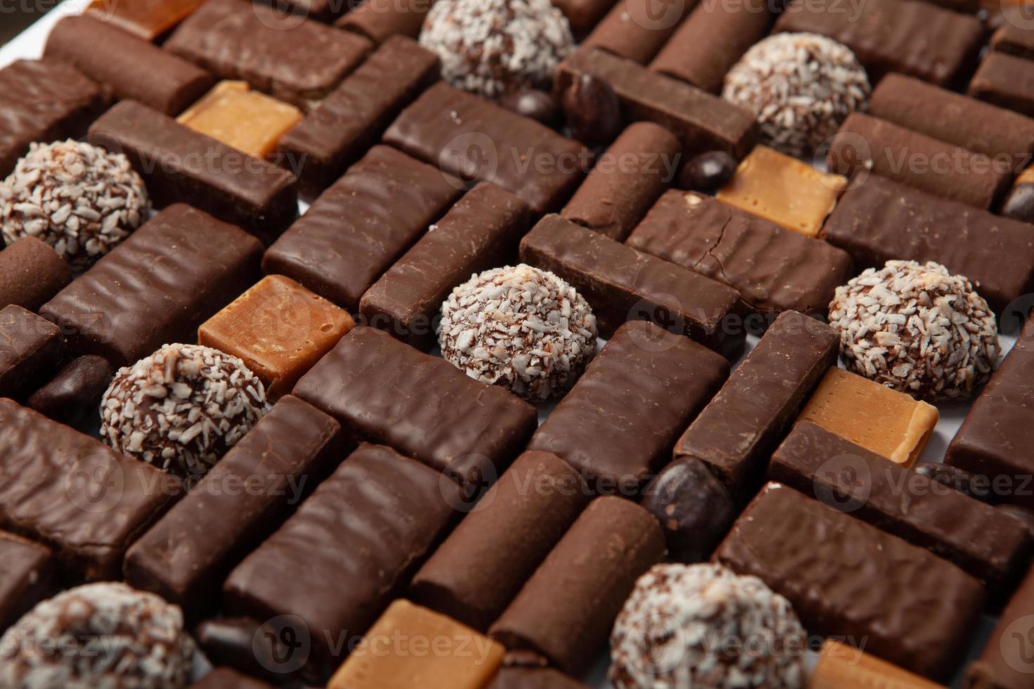 Assortment of delicious chocolate candies background. Chocolate candy isolated. photo
