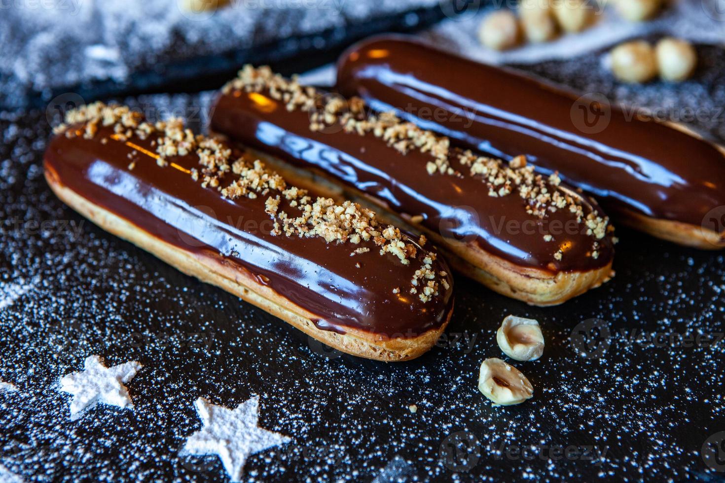 Traditional french eclairs with chocolate. Tasty dessert. Home made cake eclairs. Sweet Dessert Pastry filled with cream. Chocolate icing. photo