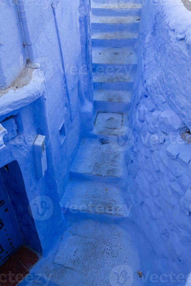 Blue street and houses in Chefchaouen, Morocco. Beautiful colored medieval street painted in soft blue color. photo