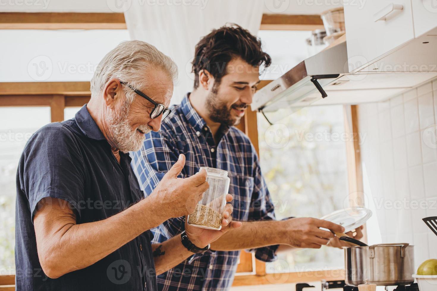 Elder cooking in the kitchen with his son, Happy family man moment good mentor old man care from son. photo