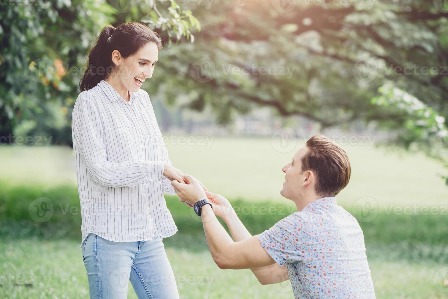 Photos of engagements, marriage proposals, and newly engaged couples lover young man and lady outdoor green park.