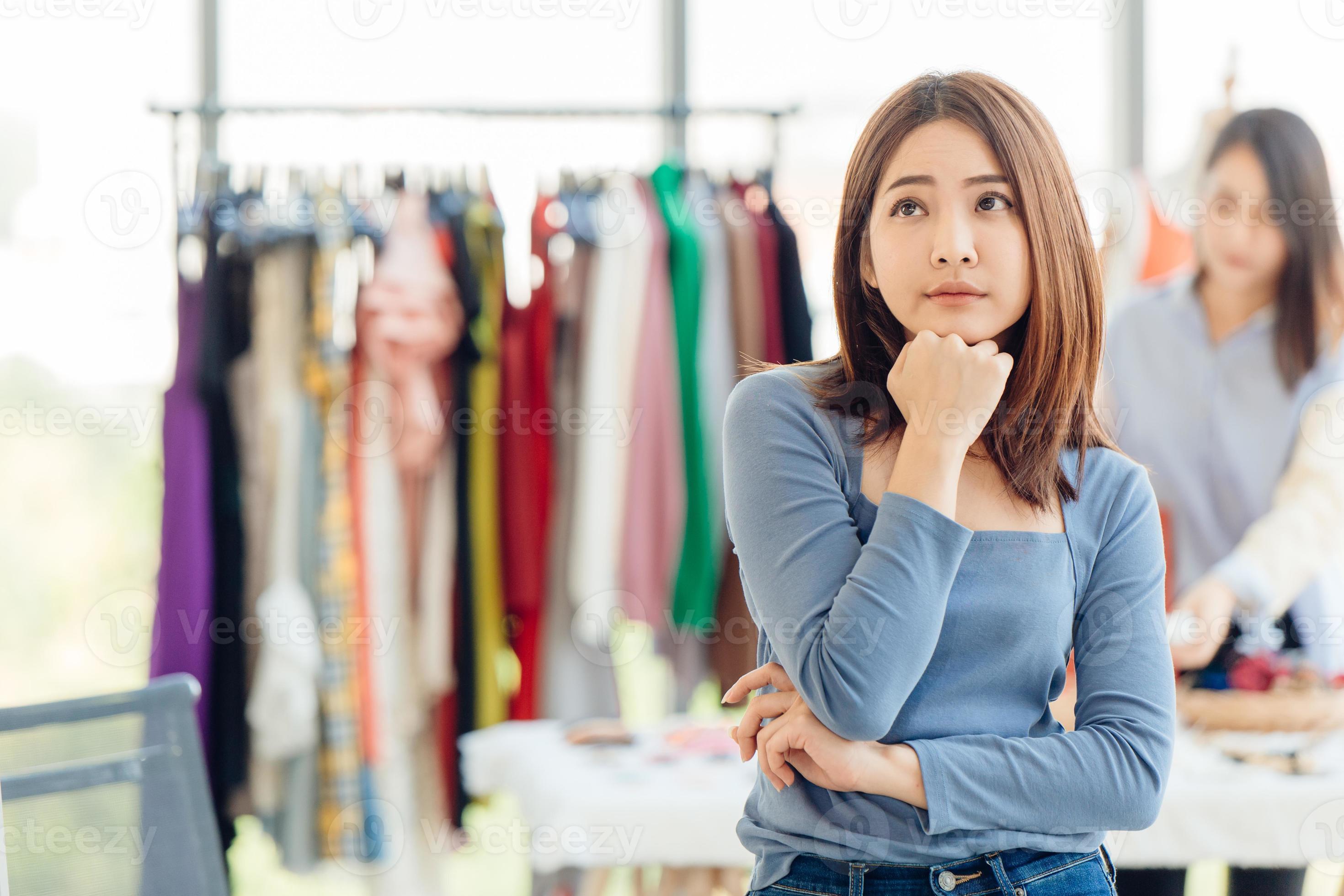 clothing shop owner thinking worry about financial problem business