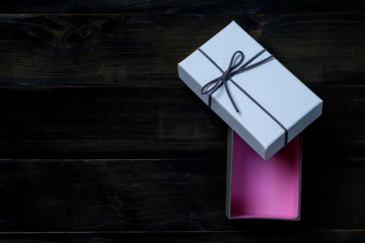 An empty cardboard box with a leather bow that is used for keeping gifts brought together on a festive day photo