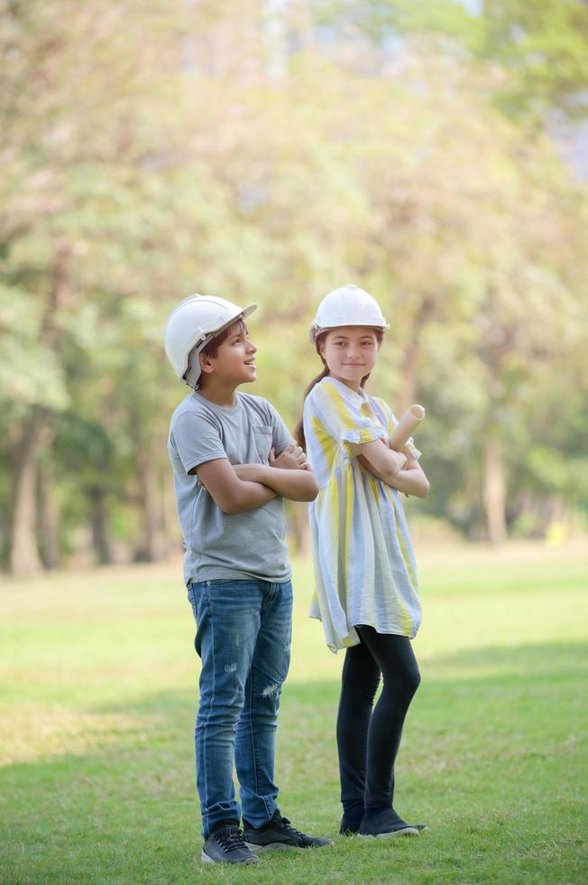 A half-Thai-Indian boy  and a mixed-Thai-European girl  holds a blueprint And expecting that in the future will be an engineer photo