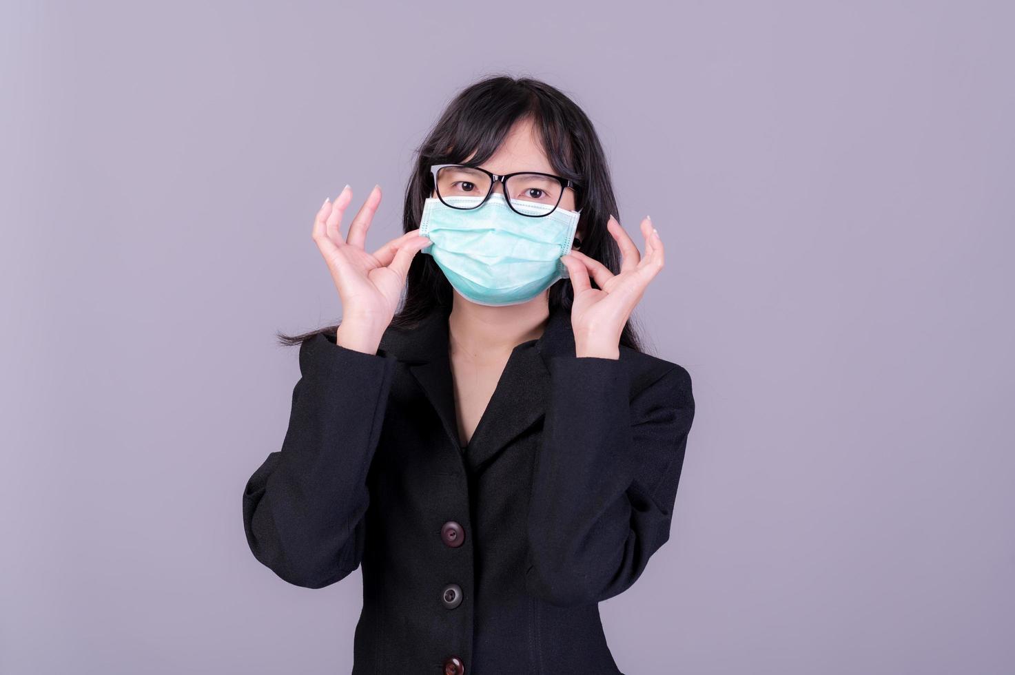 Asian business women have to use a mask to cover the face to prevent pollution from dust photo