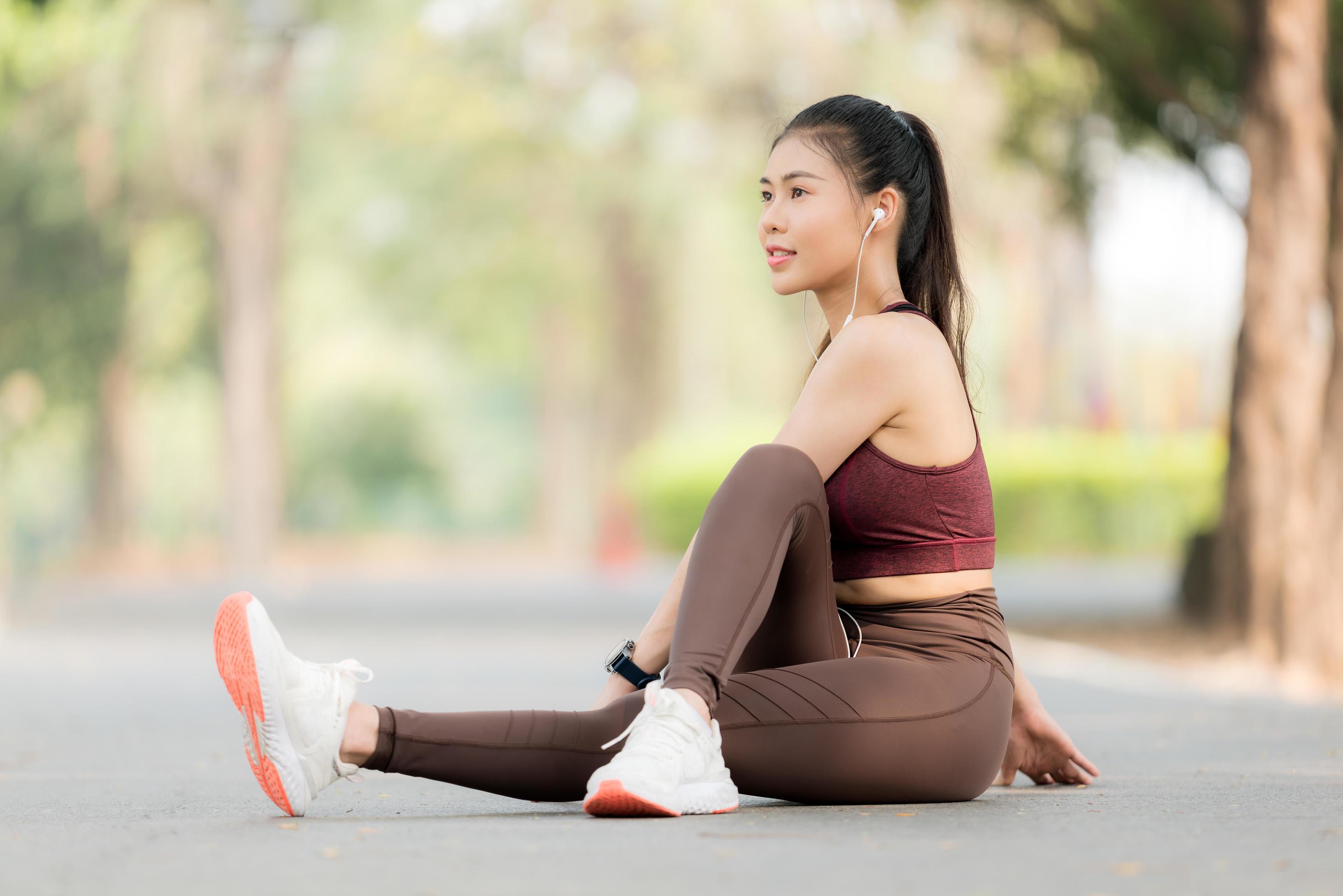 Portrait of an Asian woman with sportswear sitting on the balcony