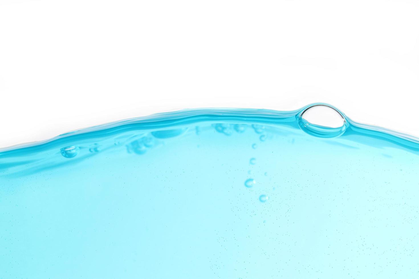 Blue surface water and air bubble isolated on white background photo