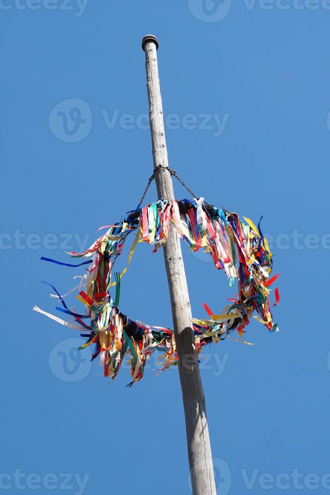 traditional german maypole against blue sky photo