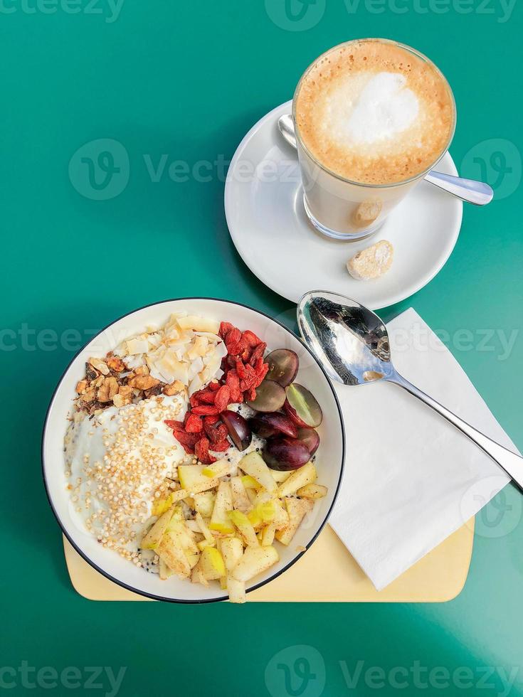 healthy breakfast bowl with fresh fruit and flat white coffee photo