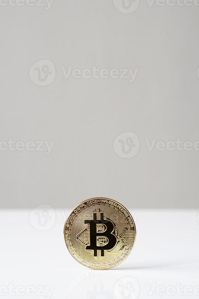 bitcoin cryptocurrency physical coin standing upright on desk photo