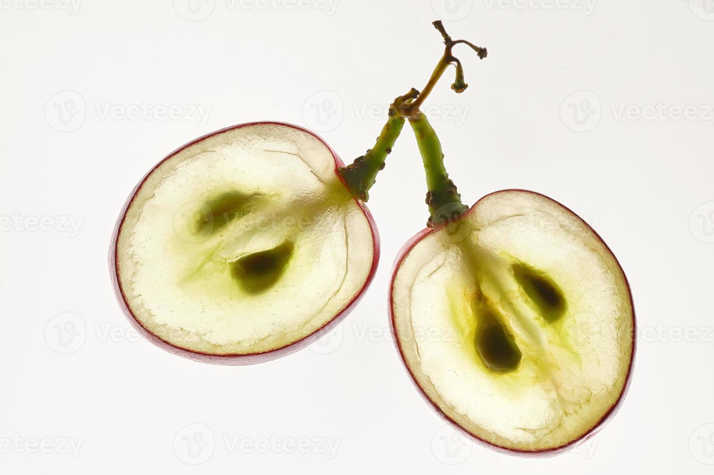 Translucent Slice Of Red Grape With Seeds In A Cut photo