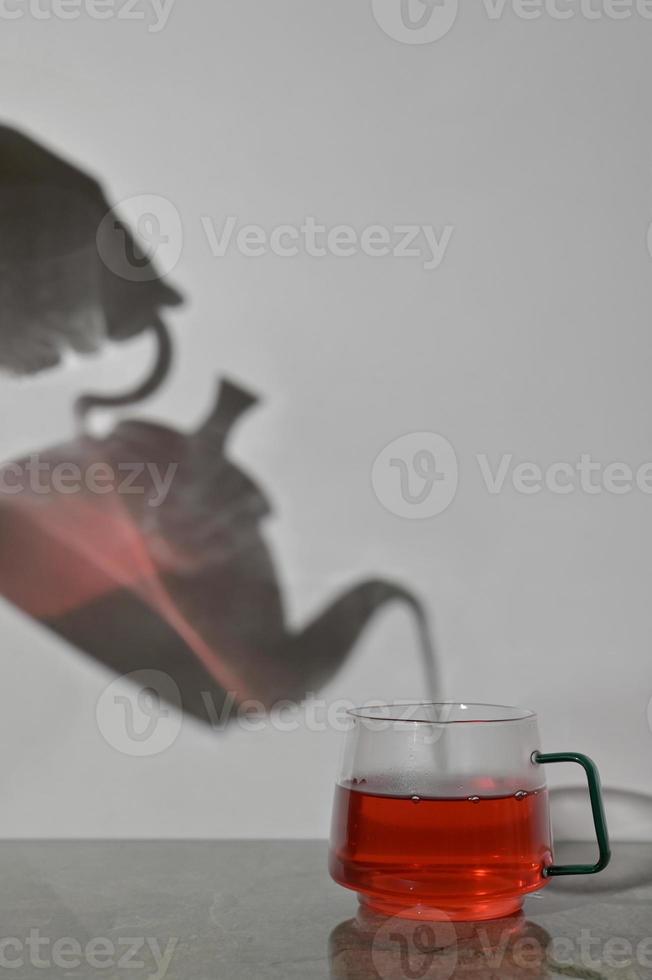 Pot and Cup Of Tea Pouring photo