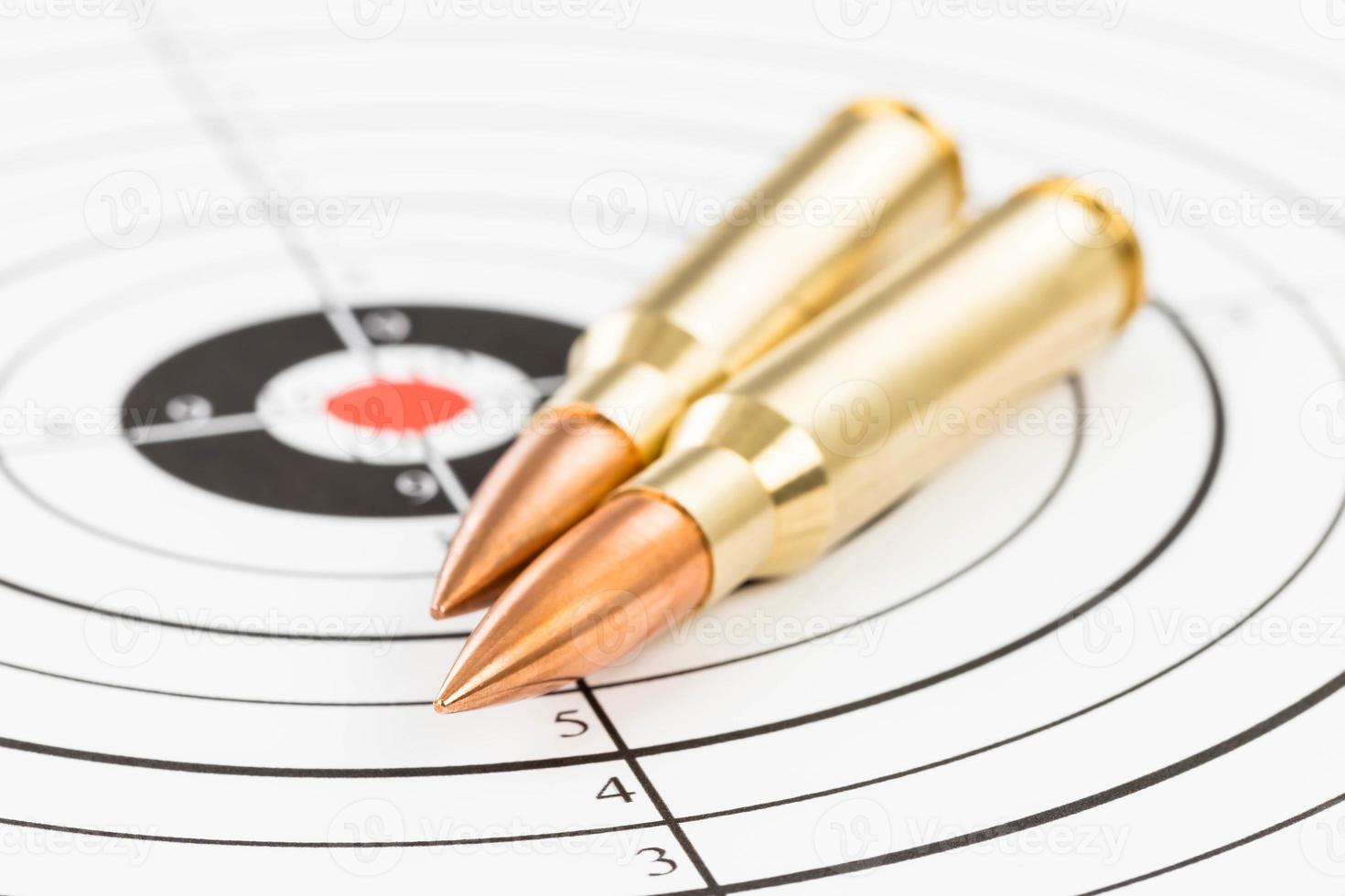 Rifle bullet over target background photo