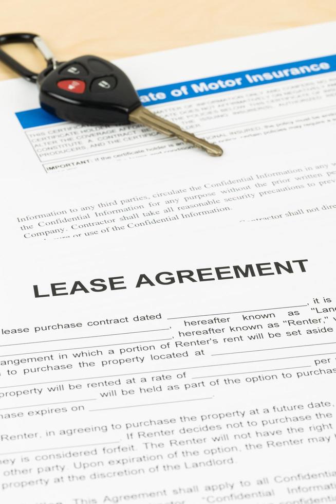 Lease agreement with car key, document is mock-up photo