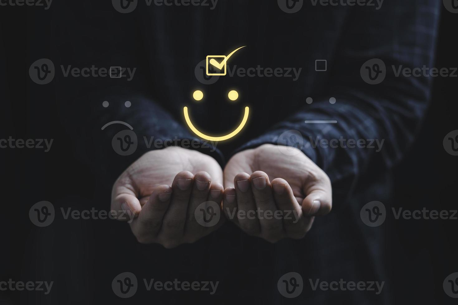 Two hands holding and select smiley face icon for client evaluation and customer satisfaction after use product and service concept. photo