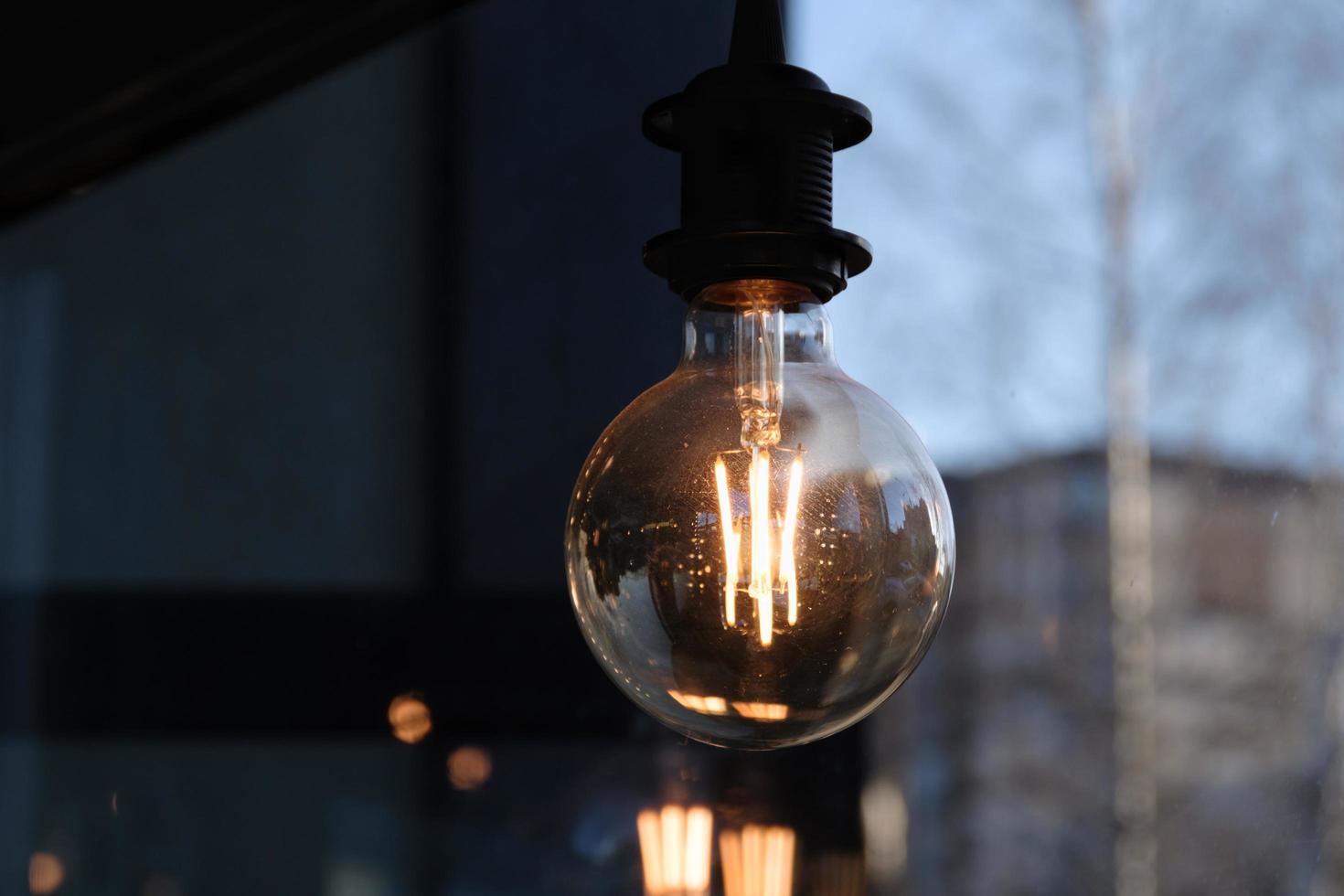 Closeup of a modern vintage-like Edison lamp hanging in the cafeteria photo