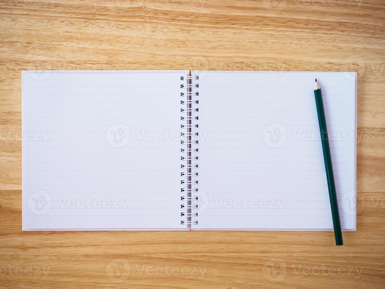 notebook top view with pencil on brown wood desk photo