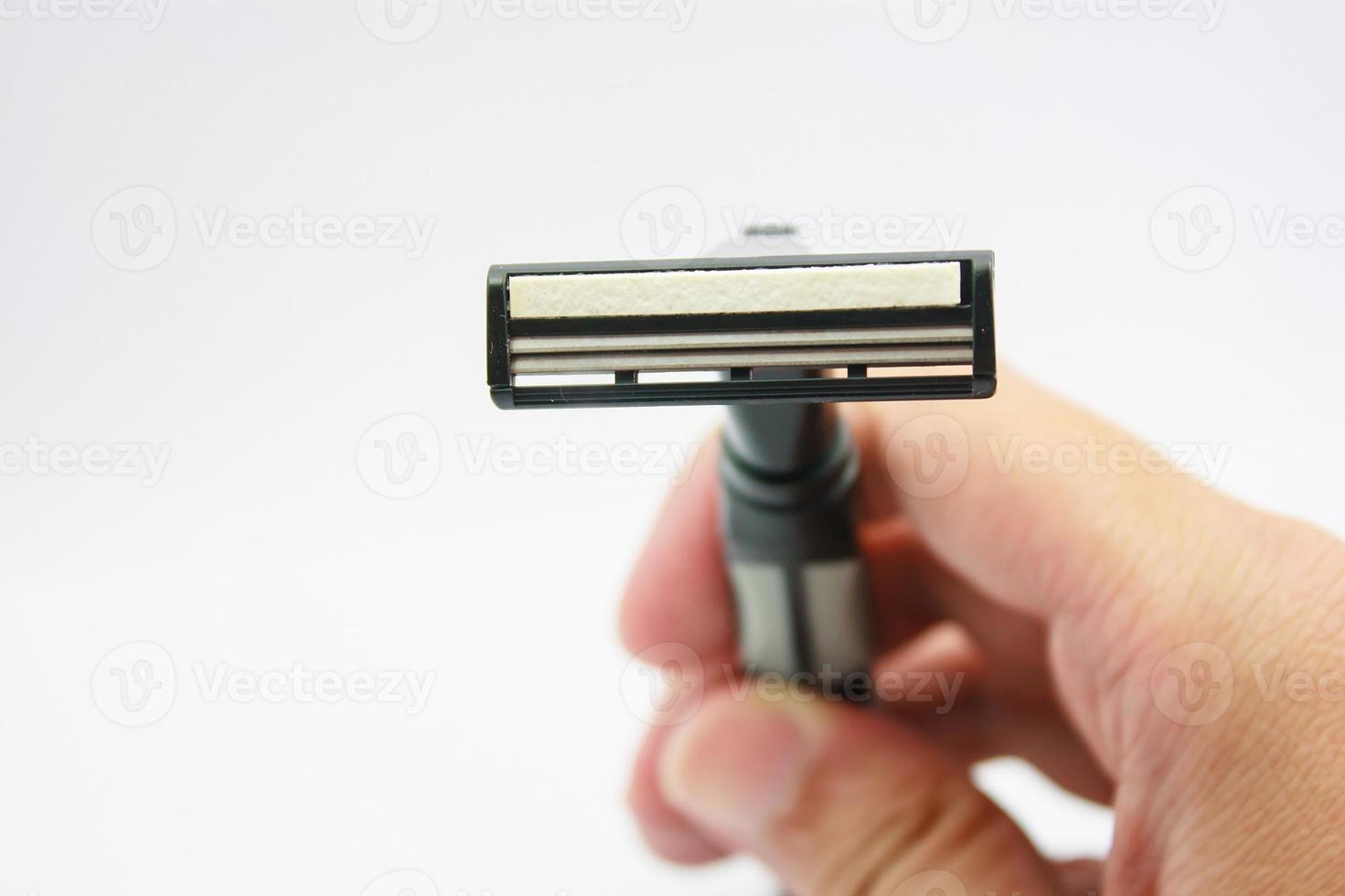 Hand with shaving razor isolated on a white background photo