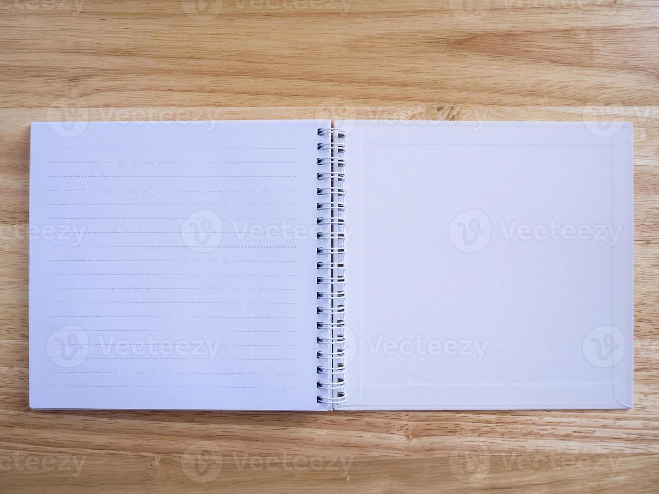 open notebook on wood table background photo