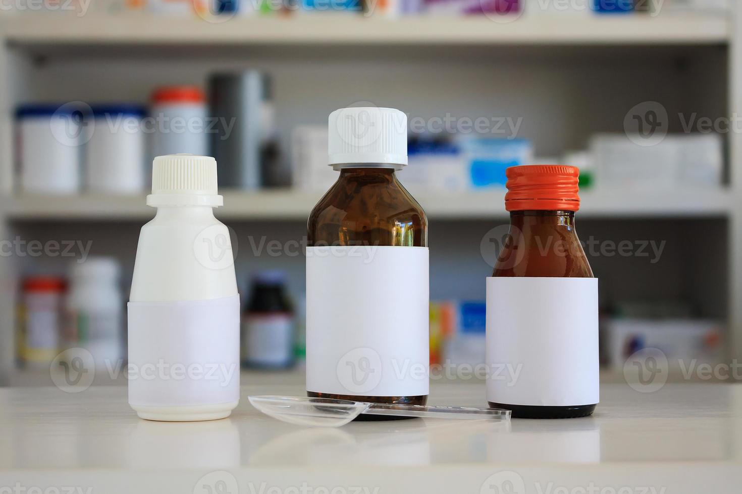 Blank white label of medicine bottle with blur shelves of drug in the pharmacy drugstore background photo