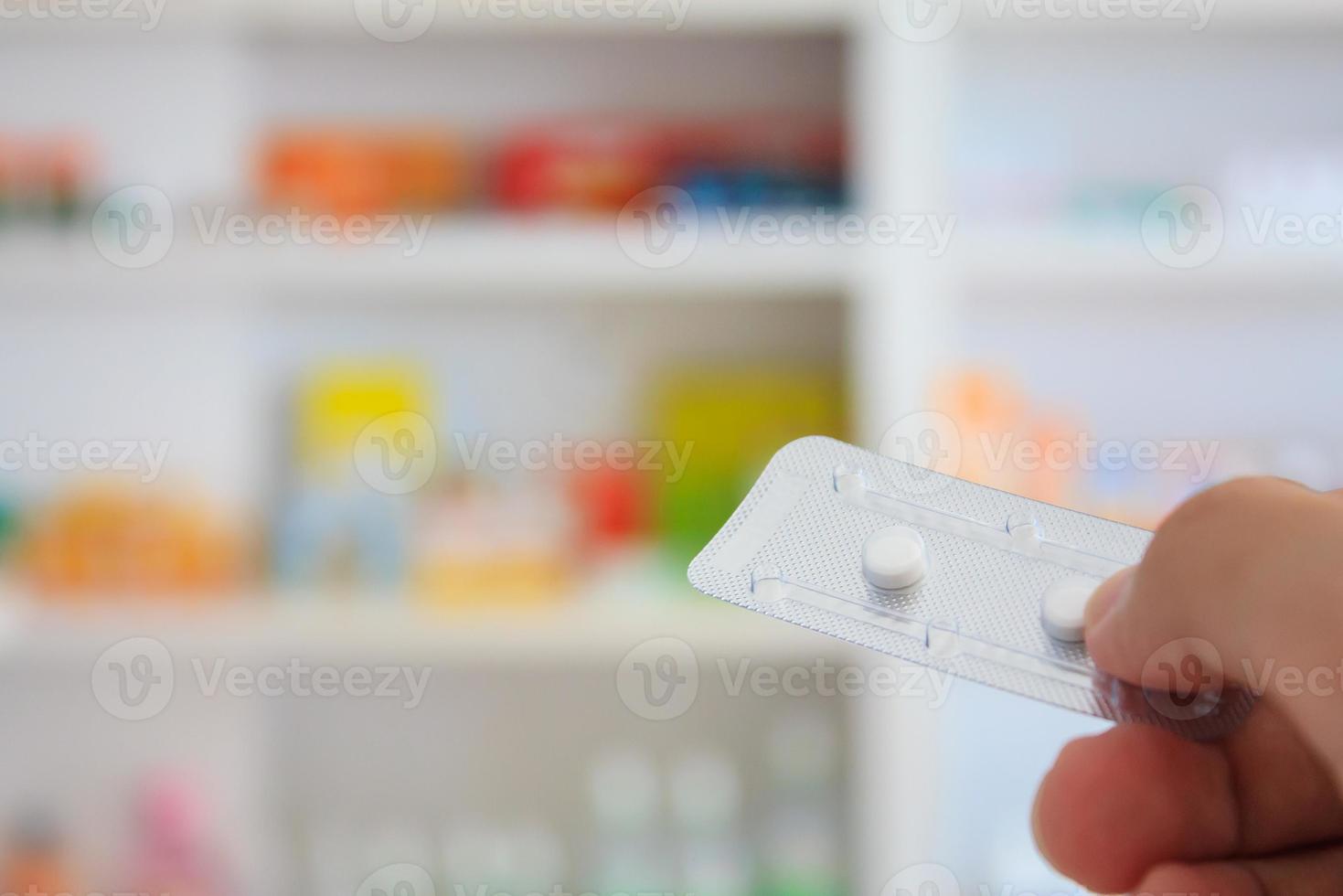 Close up of pharmacist hands holding contraceptive pills photo