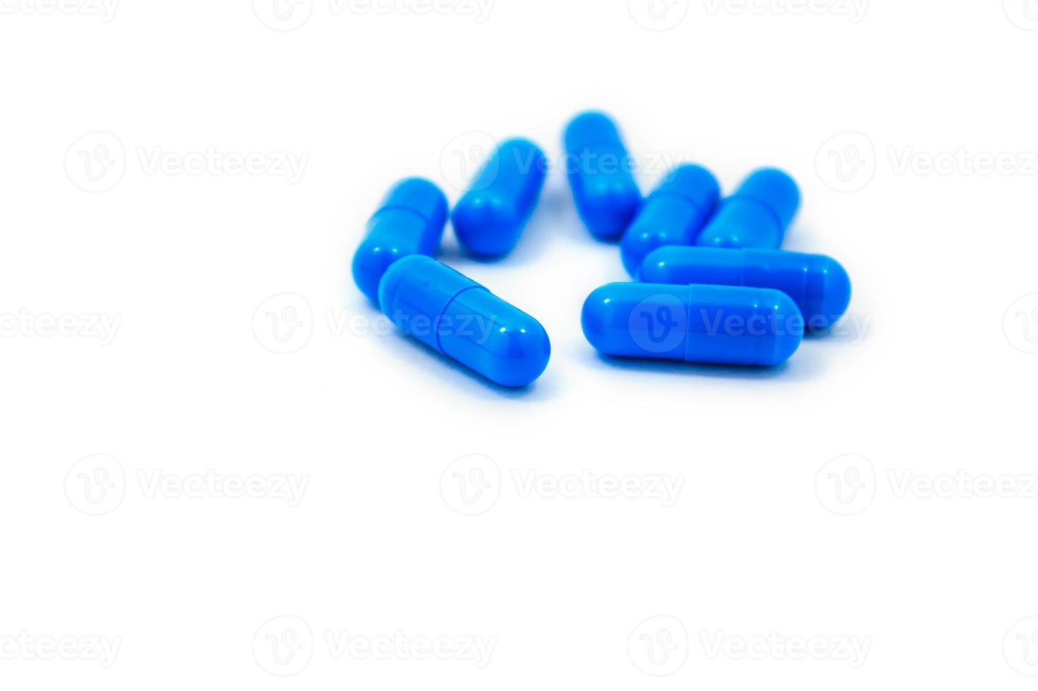 blue capsules on a white background photo