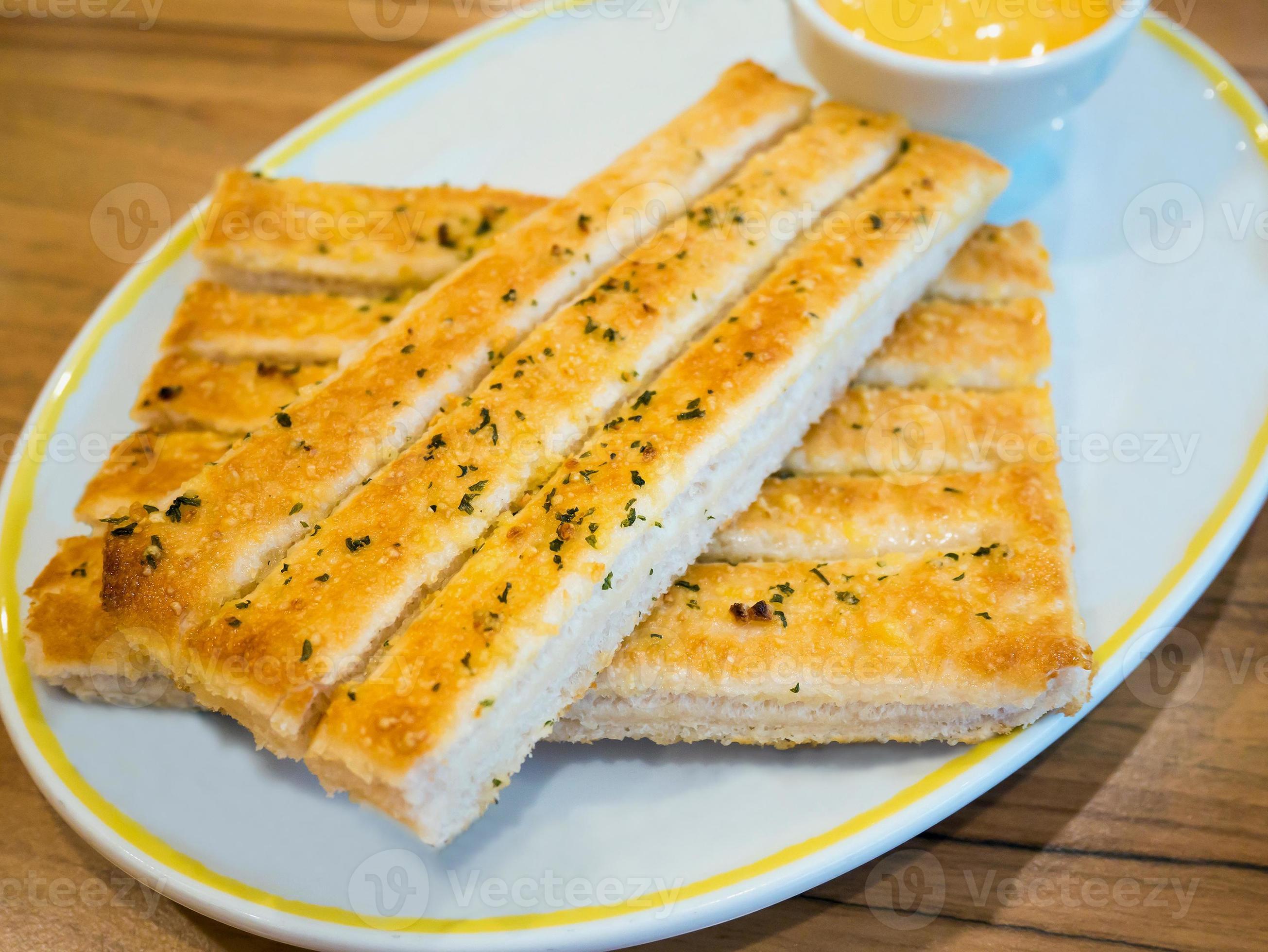 Fresh breadsticks served with dip sauce on white plate 7041660 Stock