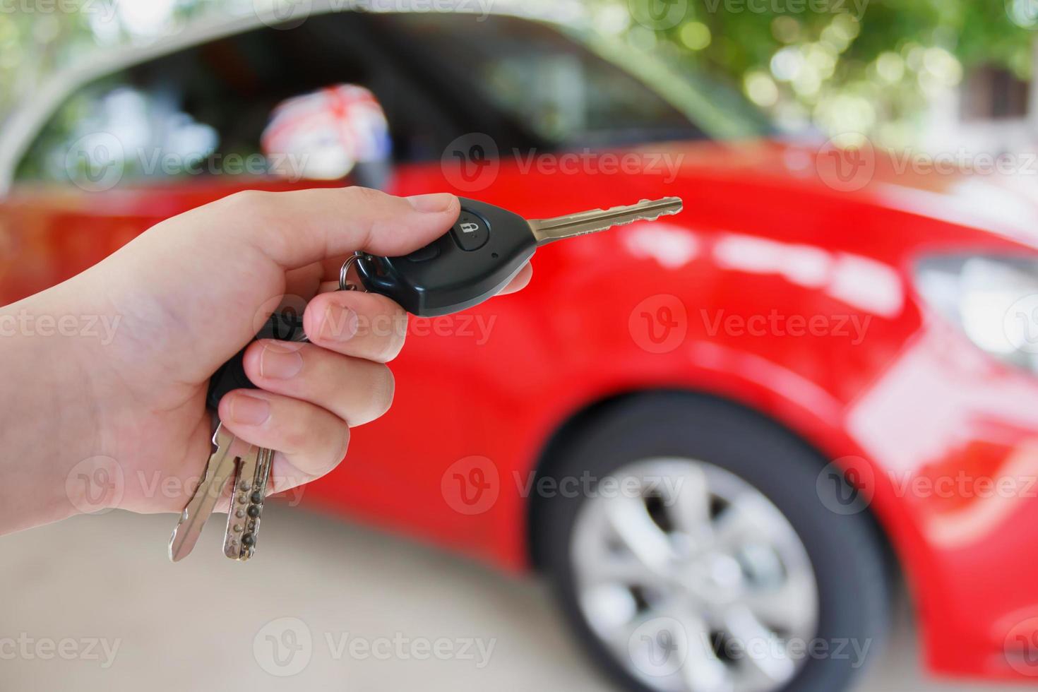 women hand presses on the remote control car alarm systems photo