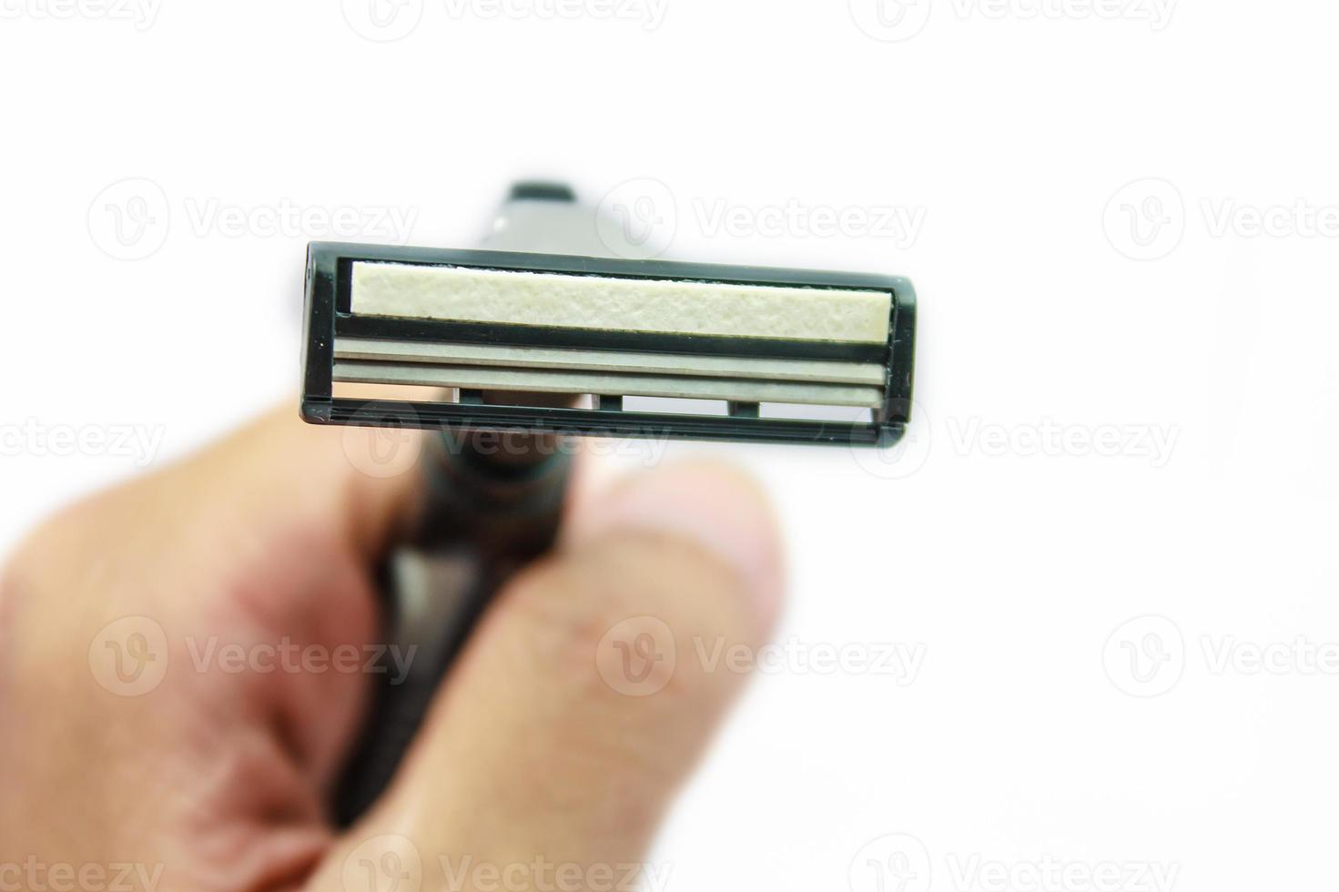 Hand with shaving razor isolated on a white background photo